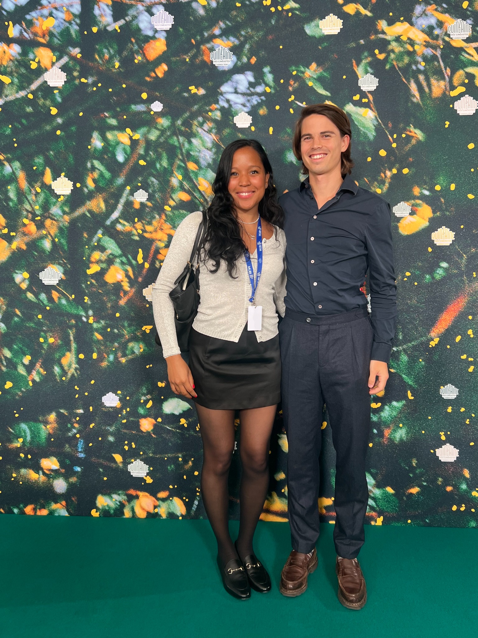 Oscar and Amber posing in front of a floral wall