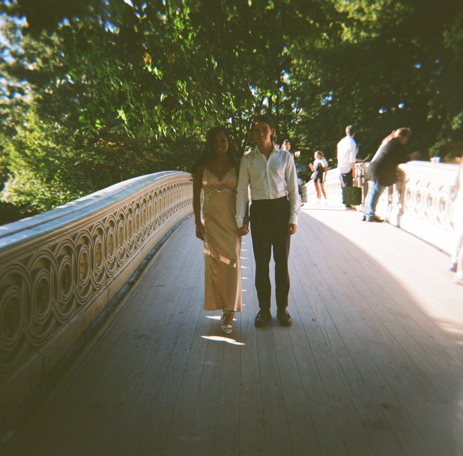 Oscar and Amber holding hands on a bridge